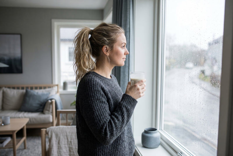 A protein shake by a rain-streaked window